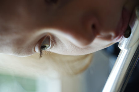 Intimate close-up of a child playing the flute, focusing on concentrated facial features and the...
