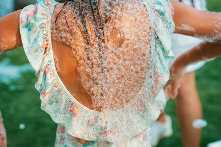 Child Enjoying Bubble Play Outdoors in Summer
