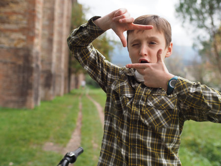 Boy Framing With Hands in Outdoor Settingの写真素材