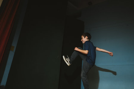 Child Kicking in Motion Captured Indoorsの写真素材