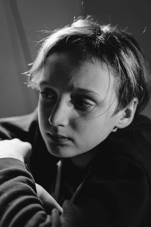 Black and white portrait of a teenager looking thoughtful and contemplative. Captures an introspective moment with a focus on deep emotions and reflective expression.の写真素材