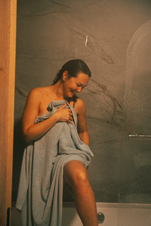 Woman Smiling After Shower Wrapped in Towel
