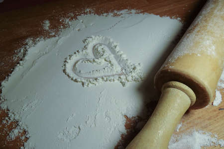 Rolling pin on the table with flour