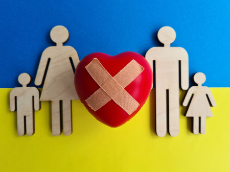 Family of citizens with children and heart on background of flag of Ukraineの写真素材