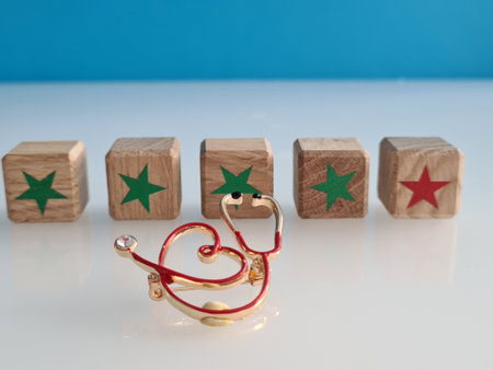 Medical stethoscope cubes with five stars and health insurance. Concept of service quality...
