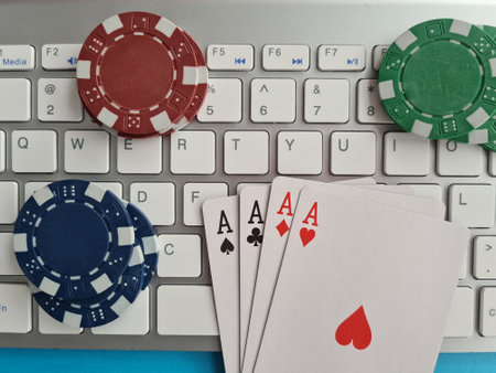 Computer keyboard four aces and cards casino chips and dice closeup. Concept of gambling, online...