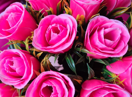 Bouquet of pink roses with stems. Beautiful composition of artificial flowers conceptの写真素材