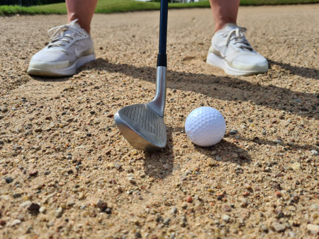 Golf shot from sand bunker golfer hitting ball from danger. sand golf courses