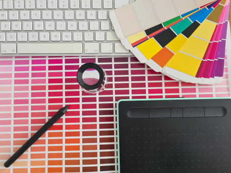 Graphic tablet stylus and color palette on table. Training for profession of designer conceptの写真素材