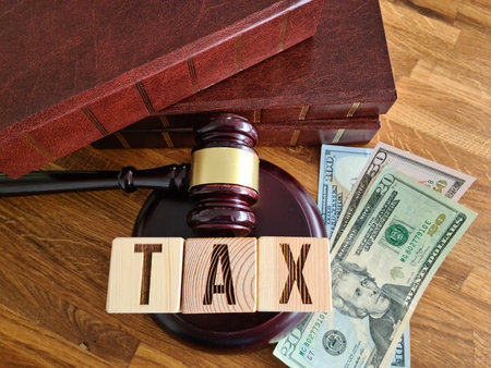 Tax law tax with gavel and money on table. Presence of debt or overpayment and concealment of financial incomeの写真素材