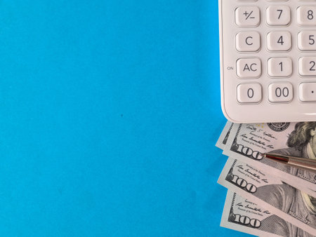 Calculator and dollars on paper with copyspace closeup. Payment of taxes and financial incomeの写真素材
