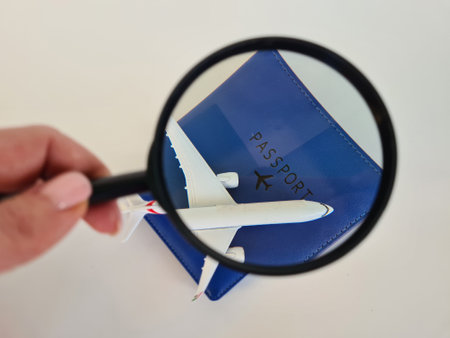 Travel passenger plane with passport and magnifiers. Search and booking of air ticketsの写真素材