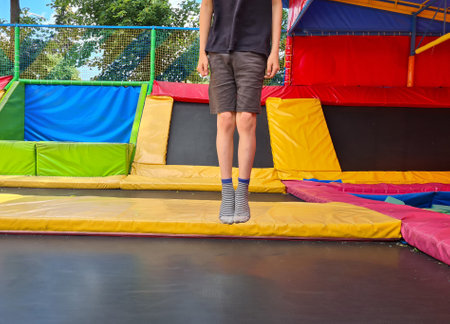 Children jumping on the trampoline and having fun in the park. Jump on trampolineの写真素材