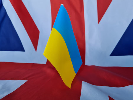 UK VS Ukraine national flags. Great Britain Ukraine politics economics relations friendship divided conflicts and aid in war conceptの写真素材
