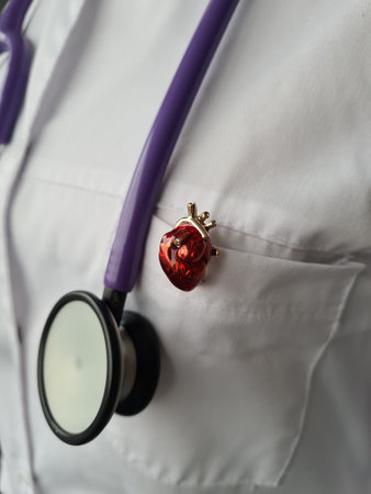 Closeup of woman cardiologist and red heartbeat icon on pocket. Cardiology and treatment of cardiovascular diseasesの写真素材