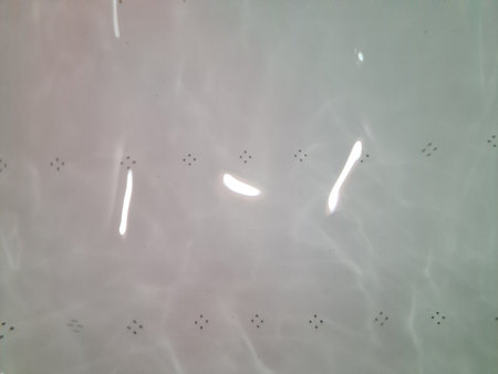 White tub with water and bottom with jets. For the texture of concept of hygiene and cleanliness.