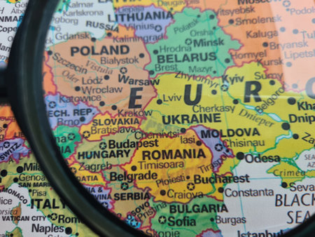 Map of Ukraine through magnifying glass and Europe. Aid to Ukraine and warの写真素材