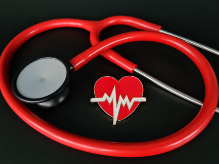 Stethoscope and heart for blood pressure check up on black backgroundの写真素材