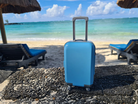 Travel suitcase on background of sea and ocean. Travel tourism and seaside holidaysの写真素材