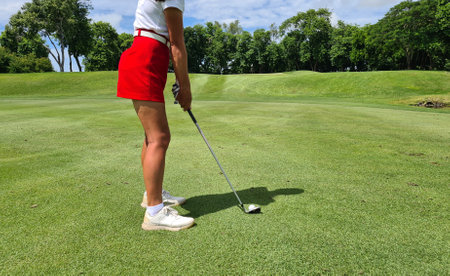 Professional woman golfer wearing sport wear teeing golf in golf tournament competition at golf course for winner conceptの写真素材