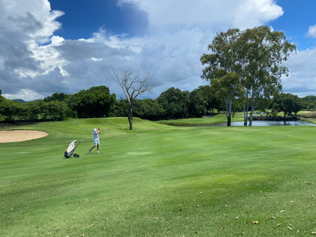 Golfer strikes with club on golf course. golf gameの写真素材