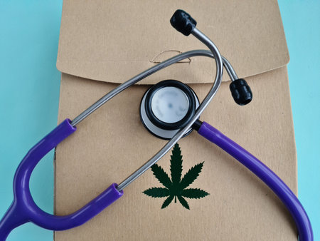 Medical marijuana and stethoscope. Packing box green cannabis leaves conceptの写真素材