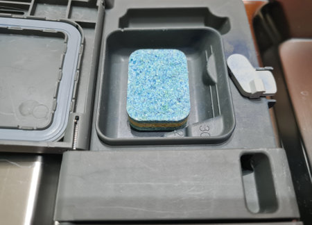Dishwasher tablet. Soap tablet in dishwasher box. automatic dishwashing conceptの写真素材