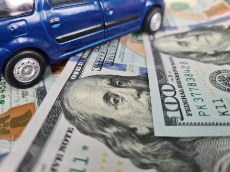 Minivan stands on scattered dollars and upgrades car. contractual financial liabilityの写真素材