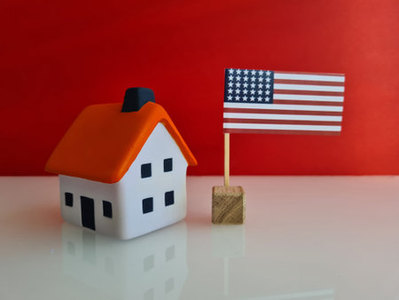 Citizenship residence permit property and real estate in America. Model of an apartment building over the American flagの写真素材