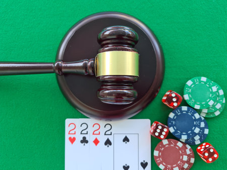 Judger gavel stands next to playing cards poker chips on green table. Responsibility for underground casino. illegal gamblingの写真素材