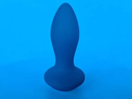 Purple sex toy butt plug isolated on blue backgroundの写真素材