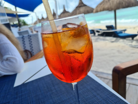 Glass of chilled cocktail with ice on seashore. Summer soft drinkの写真素材