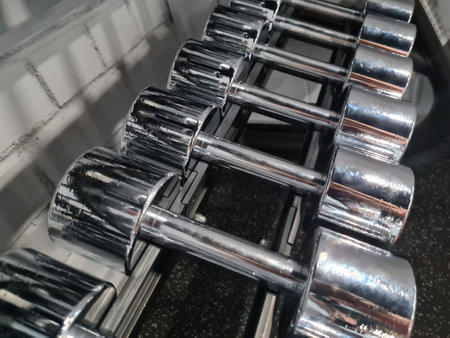 Closeup of small weight metallic dumbbells in row conceptの写真素材
