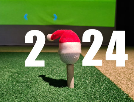 New Year and Christmas golf 2024 ball with Santa Claus hat. New golf season and New Year holidaysの写真素材