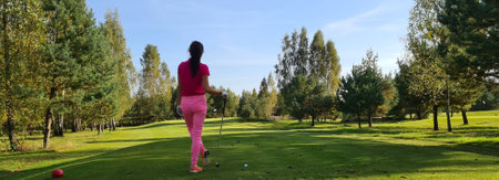 Female golfer plays golf on the course. Golf gameの写真素材