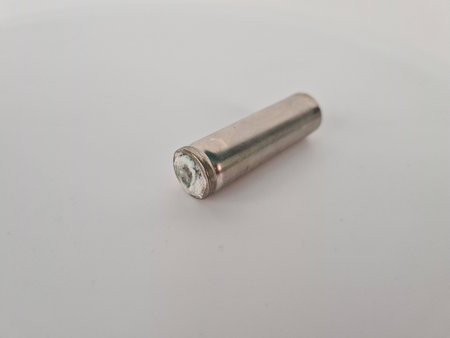 Old battery with strong signs of oxidation. Dangerous chemicals and environmental damage