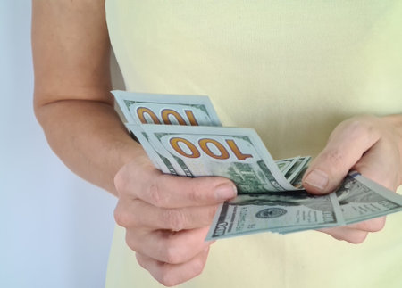Closeup of woman hands counting dollars banknote. Success, business and financial idea concept