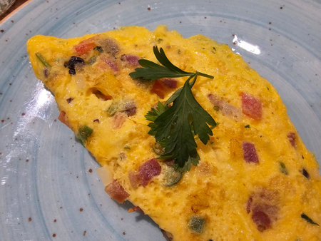 Homemade omelet with ham and peppers and cheese. Tasty breakfast