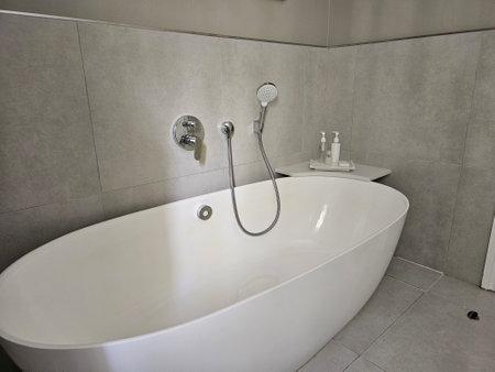 Detail of the bathtub in bathroom. Beautiful white bathtub design