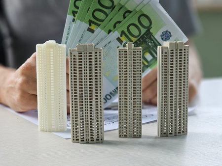 Property buyer holding euro banknotes and buying beautiful flat from real estate agenciesの写真素材