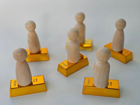 Wooden figures stand on gold bars, symbolizing wealth and investment concept