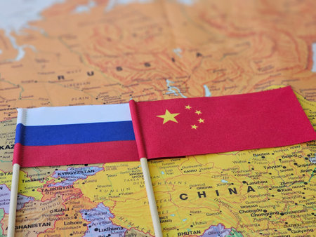 Flags of Russia and China displayed on a map representing their geographical relationship and partnershipの写真素材