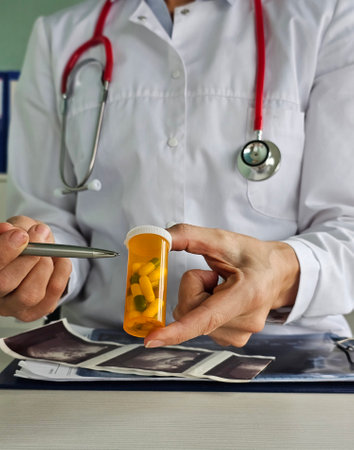 Doctor discusses prescription medications with patient during consultation in a healthcare settingの写真素材
