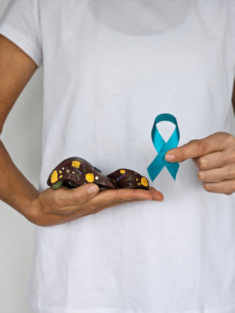 Doctor with green ribbon and liver. Liver cancer diseases causes symptoms and treatment