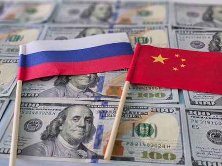 Flags of Russia and China placed on a background of US dollars representing economic relations and...