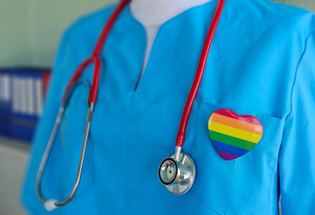 LGBT pride month or LGBTQ or LGBTQIA and health concept. Doctor with rainbow and colorful heart shape with for Lesbian, Gay, Bisexual, Transgender, Queer and Pansexual communityの写真素材
