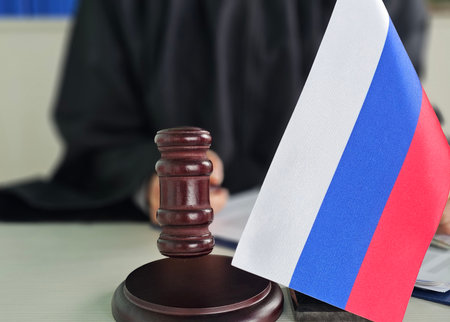 Russian flag displayed next to a gavel in a courtroom setting during a legal proceedingの写真素材