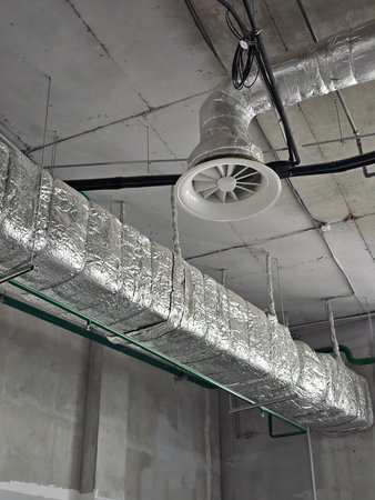 Ventilation system in an industrial setting with ductwork and air circulation components visibleの写真素材