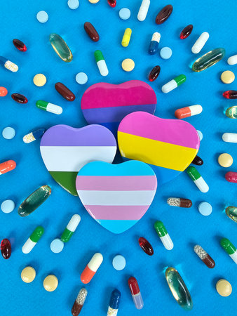Colorful heart shapes surrounded by diverse pills and capsules on a vibrant blue background