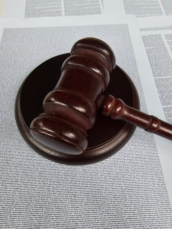 Gavel resting on legal documents in an office setting during the day